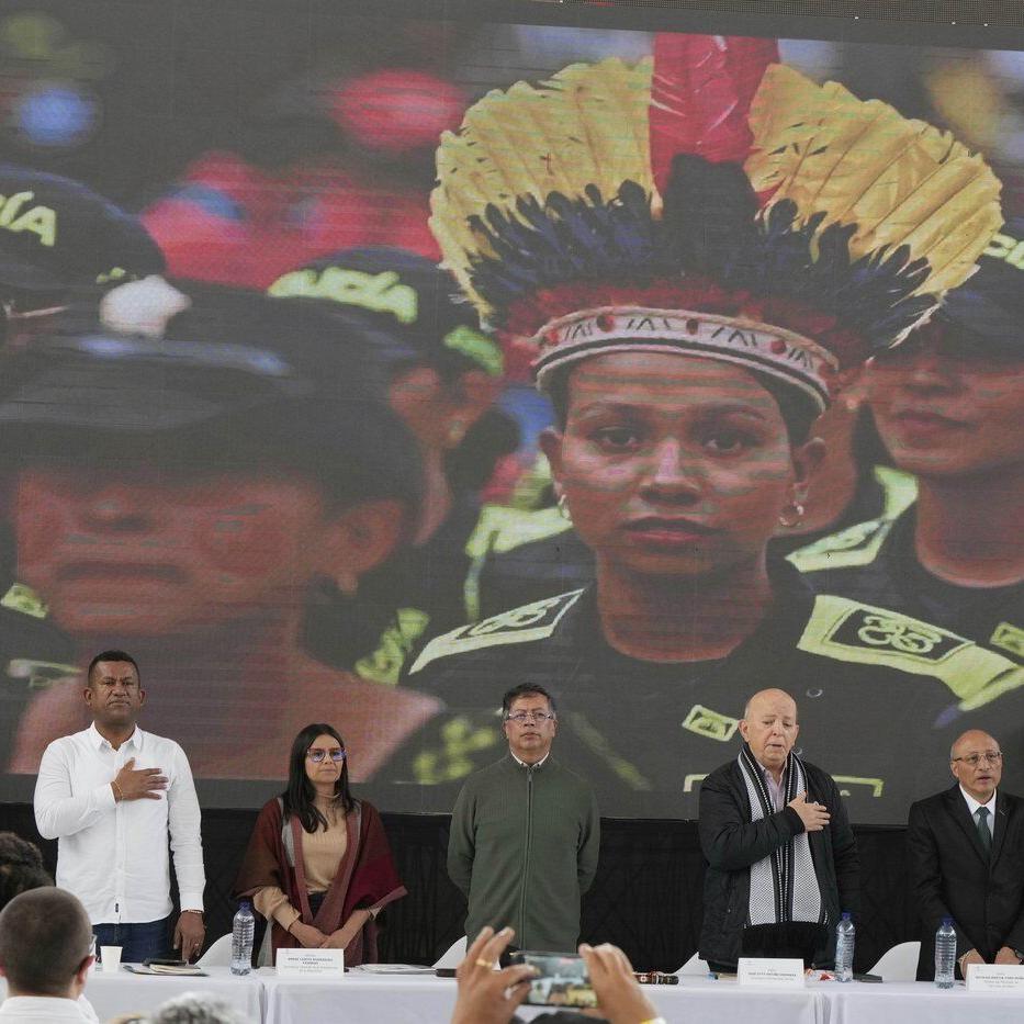 A rebel group begins handing weapons over to the Colombian government as peace talks advance
